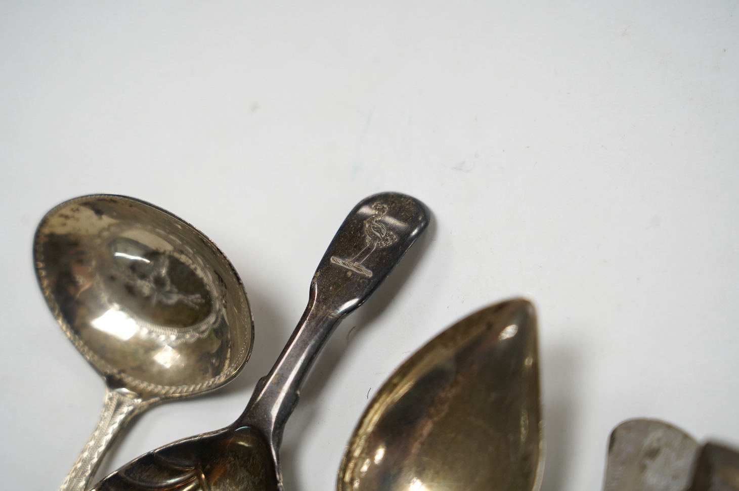 Five assorted silver caddy spoons, including shovel bowl by Cocks & Bettridge, Birmingham, 1810, 61mm, leaf bowl by William Pugh, Birmingham, 1814, Eley & Fearn, London, 1804, bright cut engraved bowl, George Baskerville